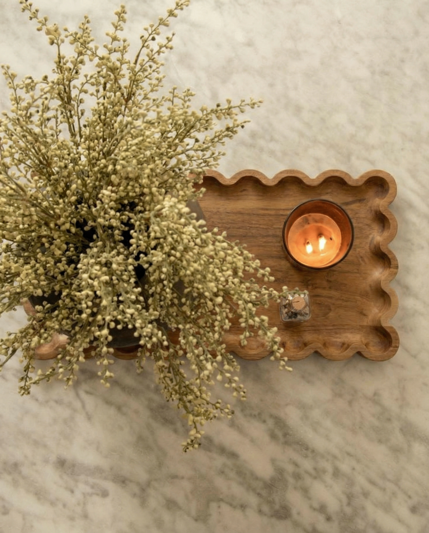 Scalloped mango wood serving tray styled with a candle and dried flowers
